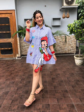 a woman wearing blue stripe print doll shirt