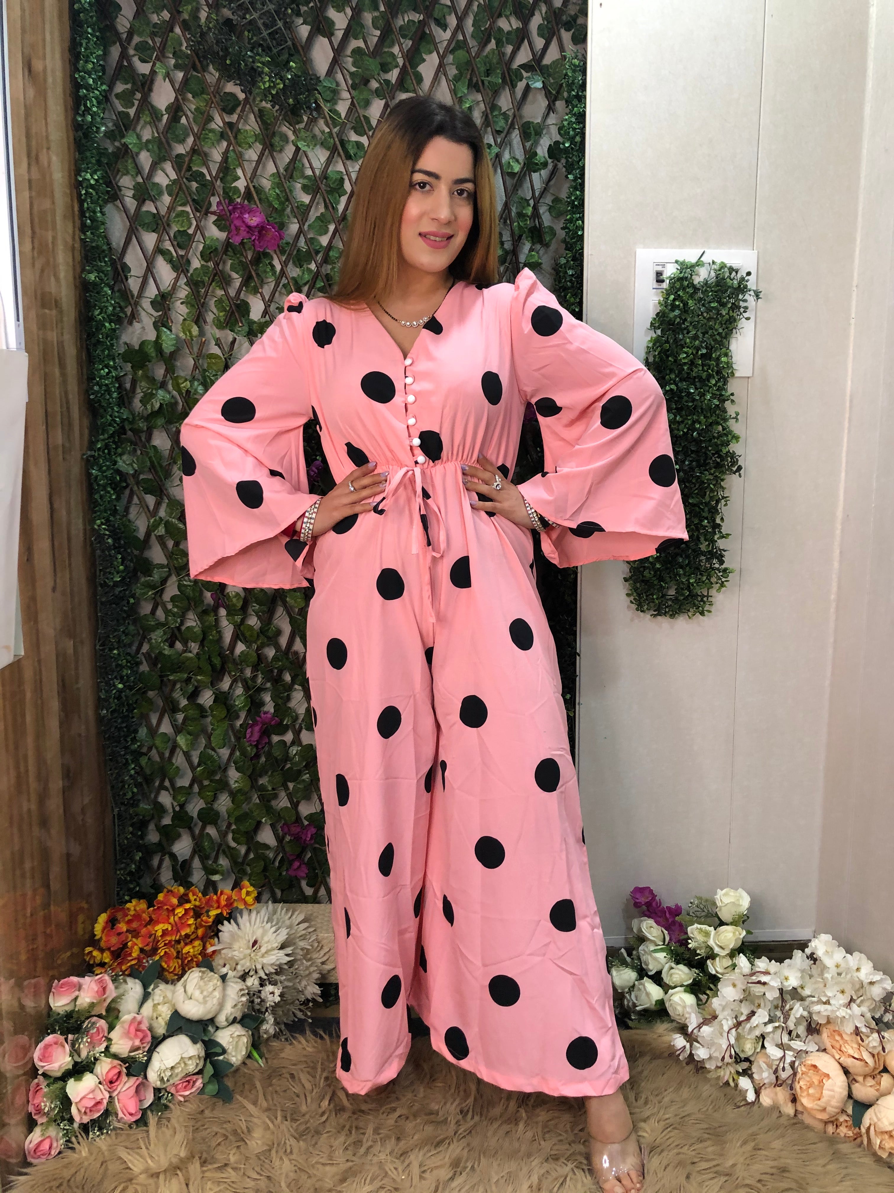 a woman wearing pink polka jumpsuit